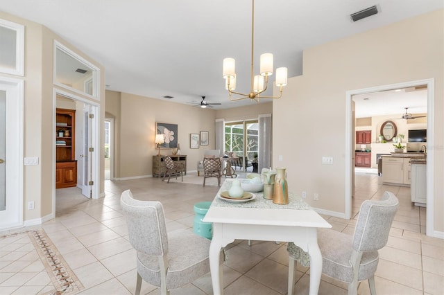 tiled dining space with ceiling fan with notable chandelier