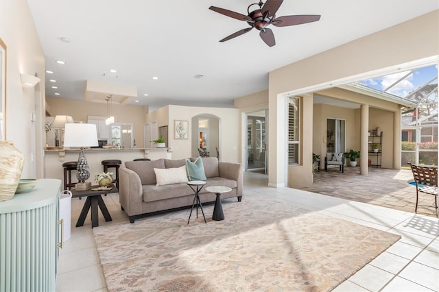 living room featuring light tile patterned floors and ceiling fan