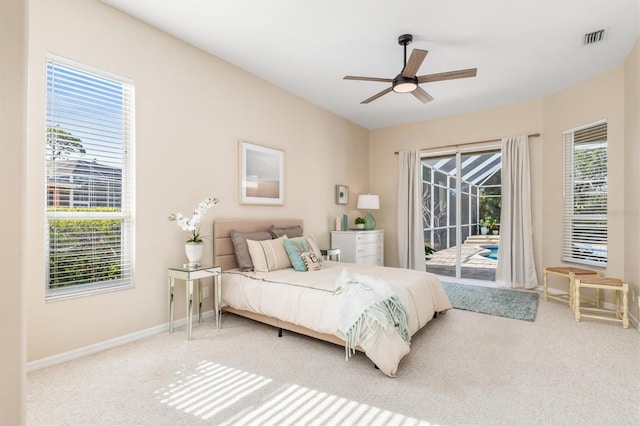 carpeted bedroom with ceiling fan and access to exterior