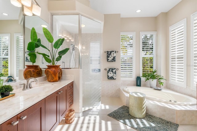 bathroom with vanity, tile patterned flooring, a healthy amount of sunlight, and separate shower and tub