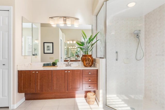 bathroom featuring tiled shower, tile patterned floors, and vanity