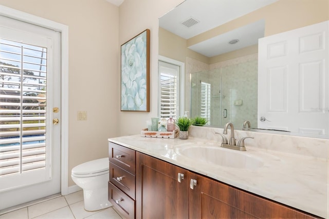 bathroom with vanity, a shower with shower door, tile patterned floors, and toilet