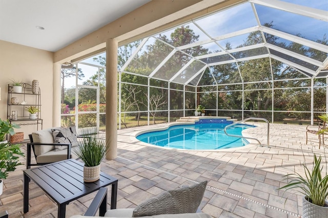 view of swimming pool with an outdoor living space, a lanai, and a patio area