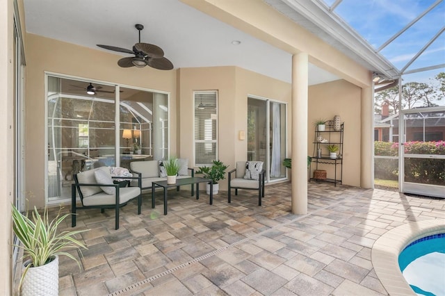 sunroom / solarium featuring ceiling fan