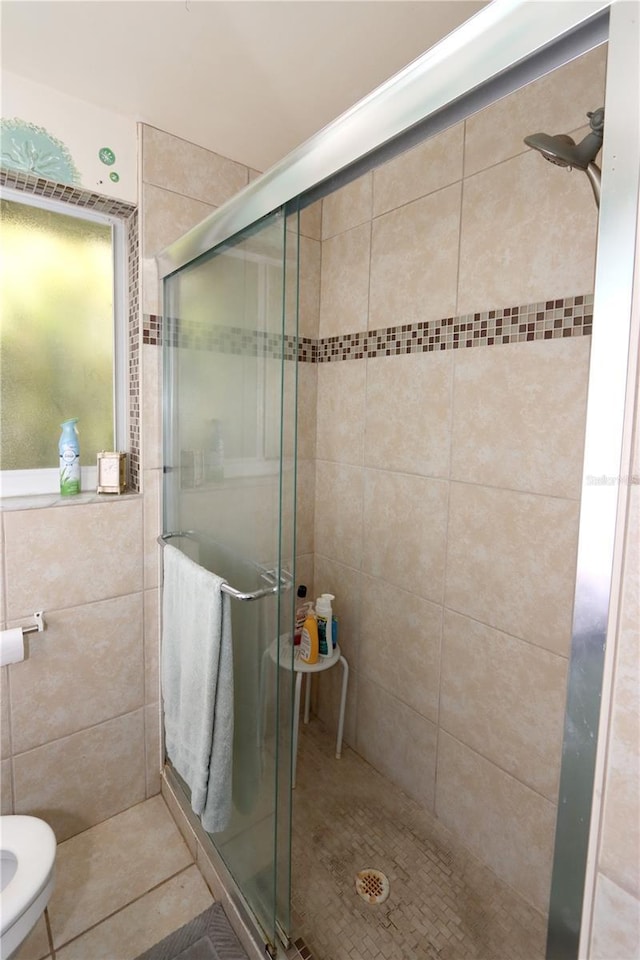 bathroom featuring a shower with door and tile patterned floors