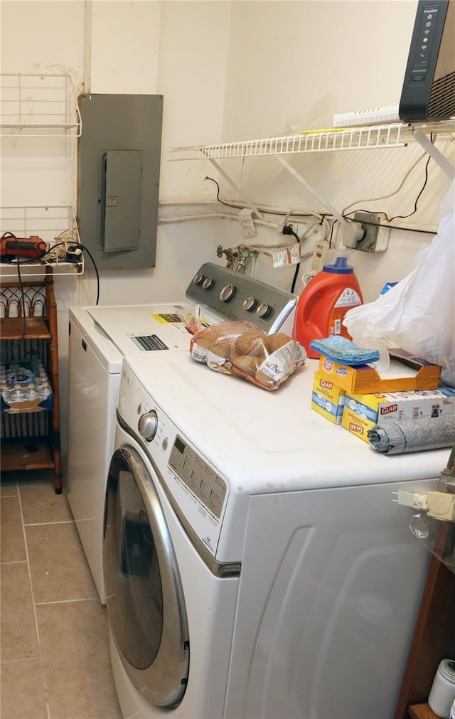 laundry area featuring light tile patterned flooring, separate washer and dryer, and electric panel