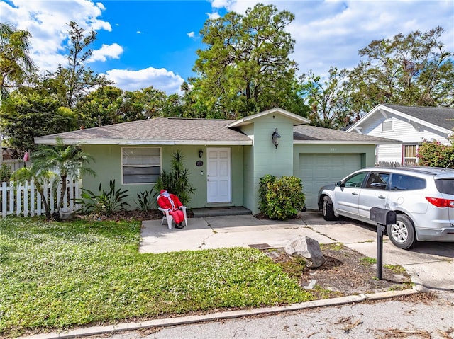 view of front of home with a garage and a front yard