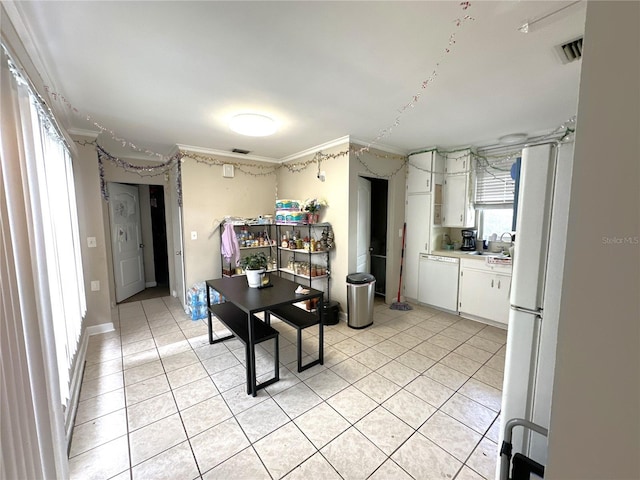 kitchen featuring crown molding, white appliances, light tile patterned floors, and white cabinets