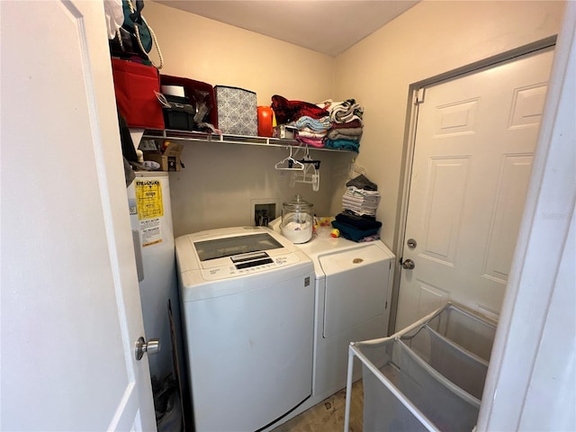 laundry room with water heater and washing machine and dryer