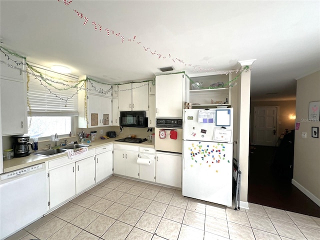 kitchen with white appliances, light tile patterned floors, sink, and white cabinets