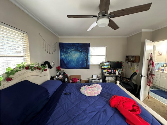 bedroom with crown molding, ensuite bathroom, and ceiling fan