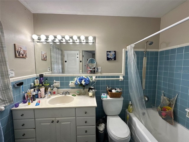 full bathroom with toilet, tile walls, vanity, and shower / bath combo with shower curtain