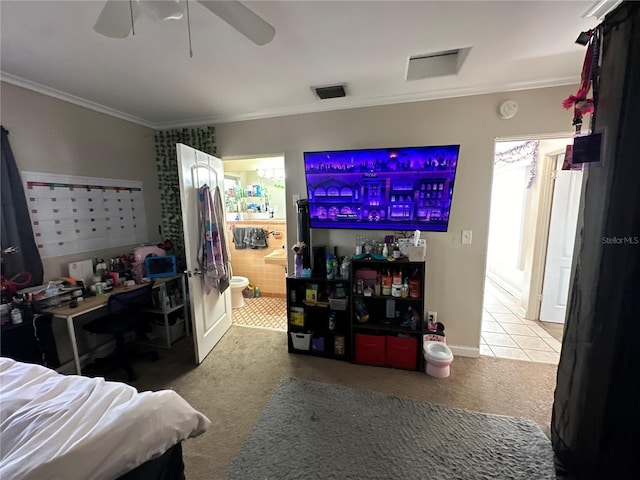 bedroom with light carpet, crown molding, ceiling fan, and ensuite bathroom