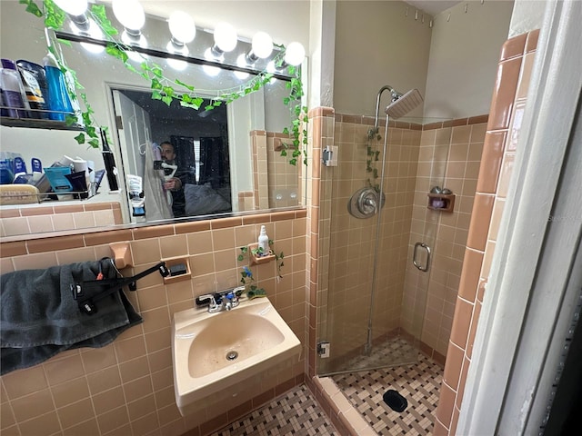 bathroom featuring sink, tile walls, decorative backsplash, and walk in shower