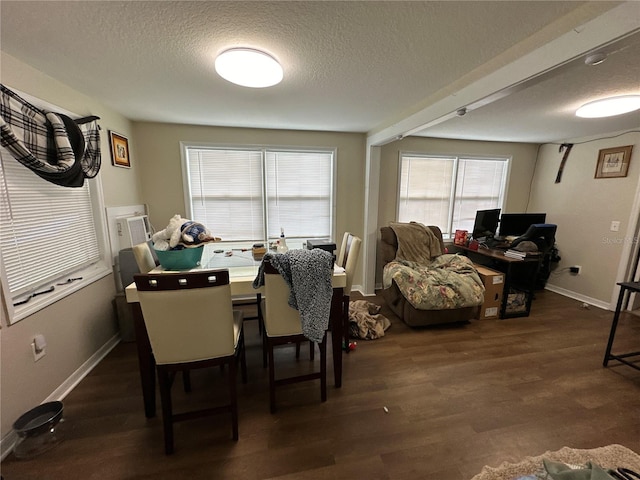 dining room featuring dark hardwood / wood-style floors and a textured ceiling