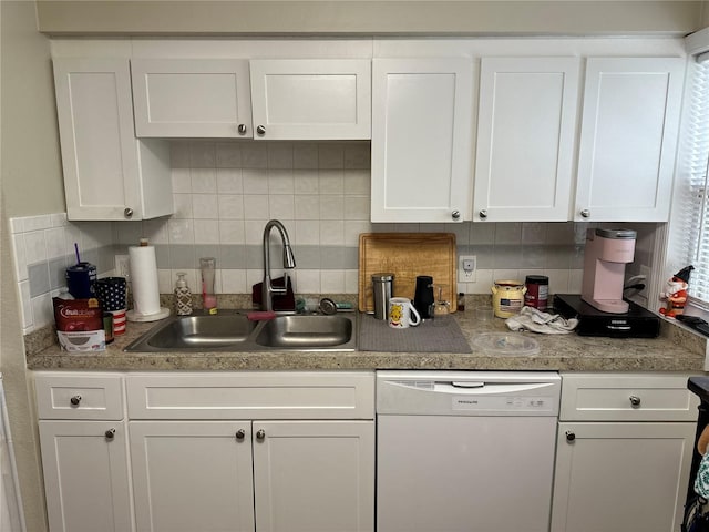 kitchen featuring dishwasher, sink, decorative backsplash, and white cabinets