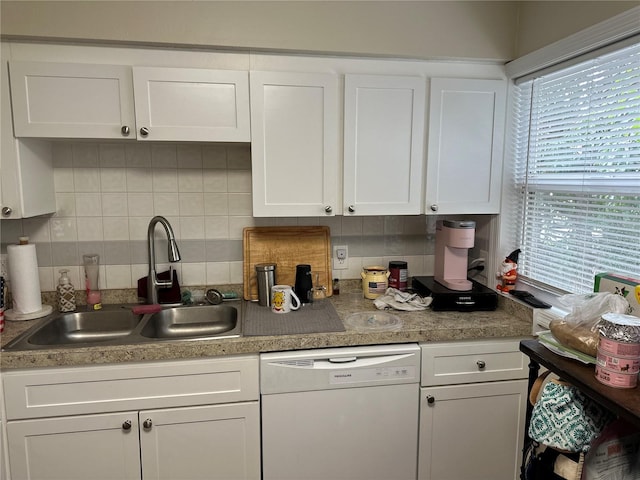 kitchen with sink, white cabinets, white dishwasher, and decorative backsplash