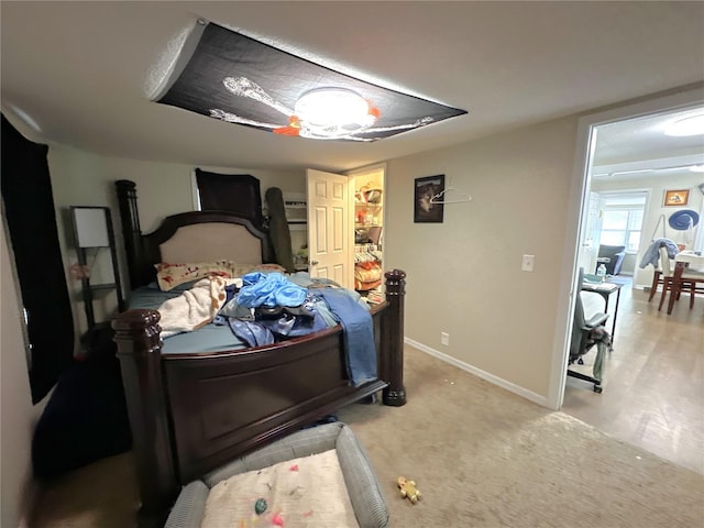 bedroom featuring light colored carpet and ceiling fan