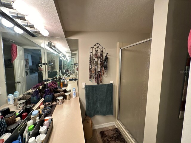 bathroom with a textured ceiling and walk in shower