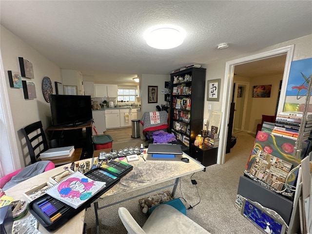 carpeted home office with a textured ceiling