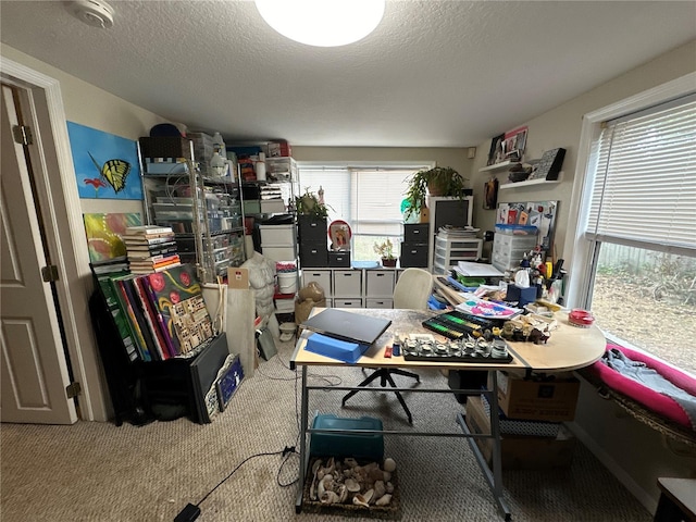 home office featuring carpet floors and a textured ceiling