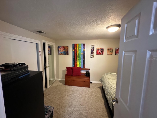 bedroom with a textured ceiling and carpet flooring