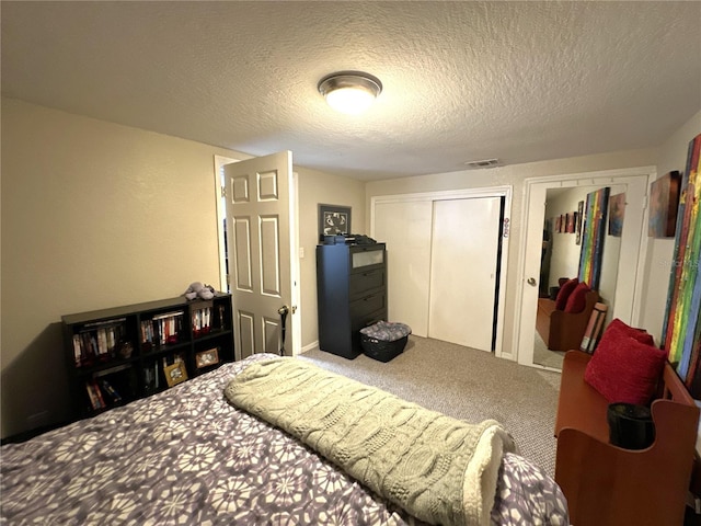 carpeted bedroom featuring a textured ceiling