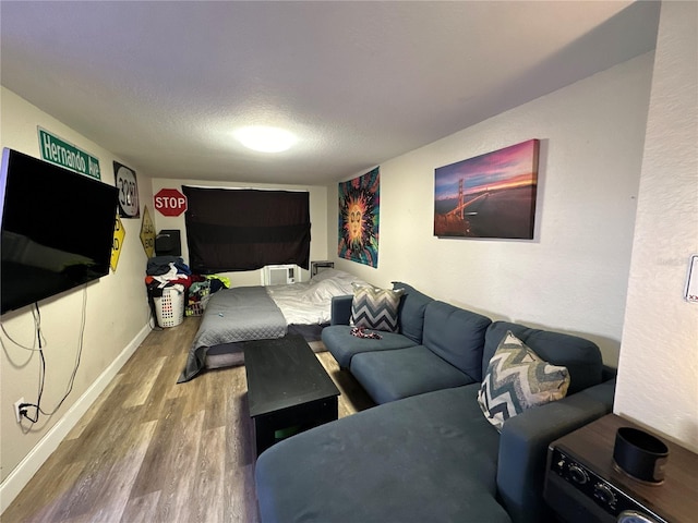 living room featuring hardwood / wood-style floors and a textured ceiling