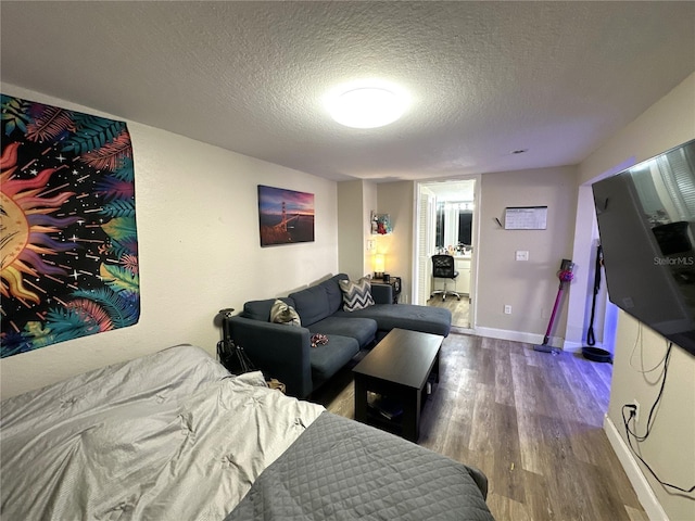 living room with dark hardwood / wood-style flooring and a textured ceiling