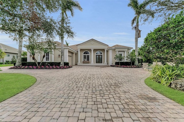 view of front of house with a garage and french doors