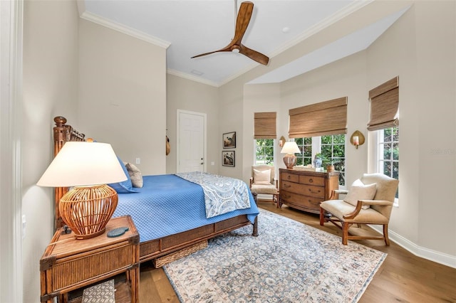 bedroom with ornamental molding, hardwood / wood-style floors, and ceiling fan