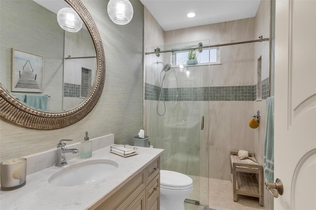 bathroom with vanity, an enclosed shower, and toilet