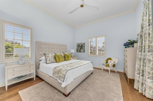 bedroom featuring wood-type flooring, ornamental molding, and ceiling fan