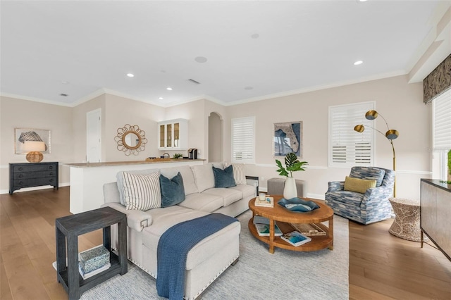 living room with crown molding and hardwood / wood-style floors