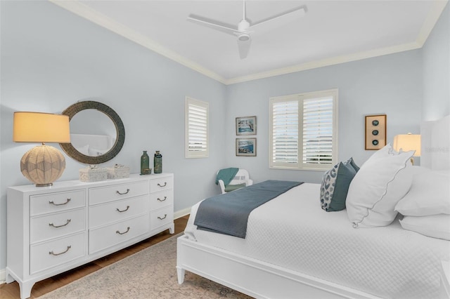 bedroom with hardwood / wood-style flooring, ornamental molding, and ceiling fan