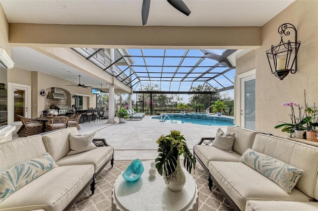 view of swimming pool featuring a patio, pool water feature, ceiling fan, glass enclosure, and an outdoor living space