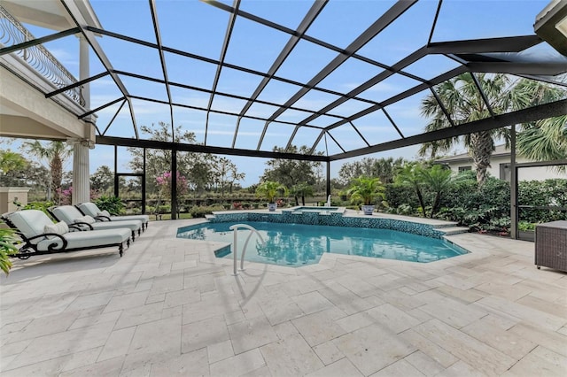 view of pool with an in ground hot tub, a lanai, and a patio area