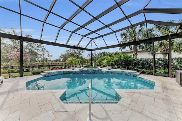 view of pool featuring an in ground hot tub, a lanai, and a patio