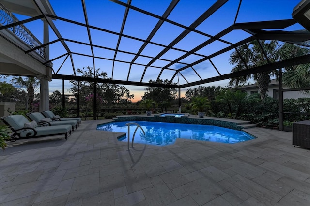 pool at dusk with a patio and glass enclosure