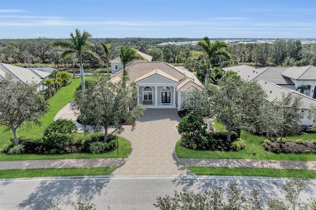 view of front of home featuring a tile roof and decorative driveway