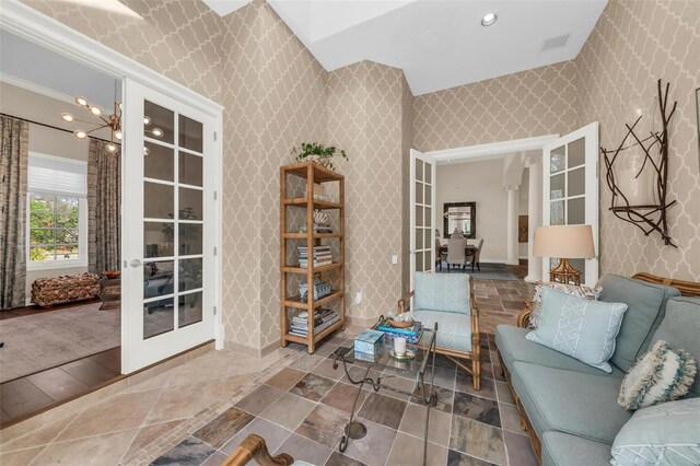 living area featuring recessed lighting, french doors, visible vents, and wallpapered walls