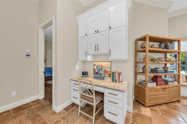 office area with ornamental molding, stone tile flooring, and baseboards