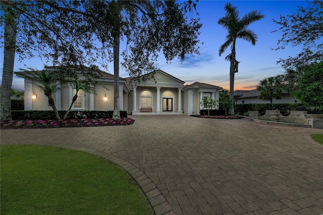 view of front of home featuring decorative driveway and stucco siding