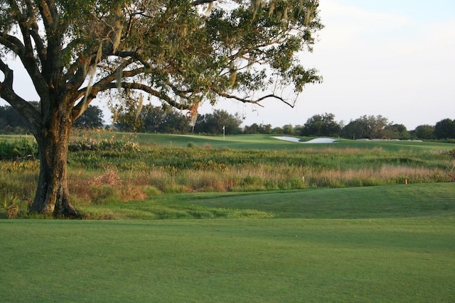 view of property's community with a yard and golf course view