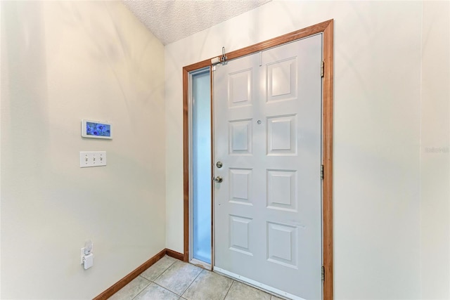 tiled foyer entrance with a textured ceiling