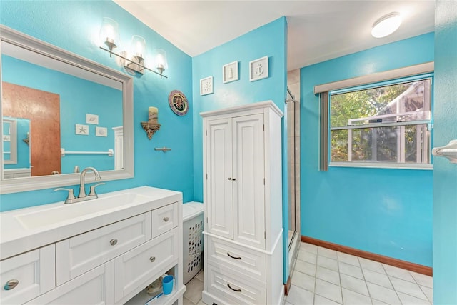 bathroom featuring vanity, a shower with shower door, and a notable chandelier