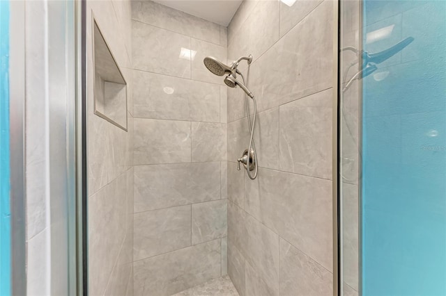 bathroom with tiled shower