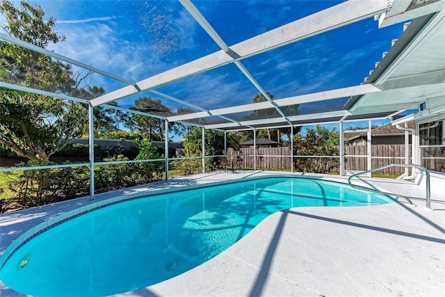 view of swimming pool featuring a lanai and a patio area