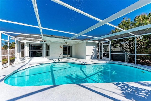 view of swimming pool featuring a lanai and a patio