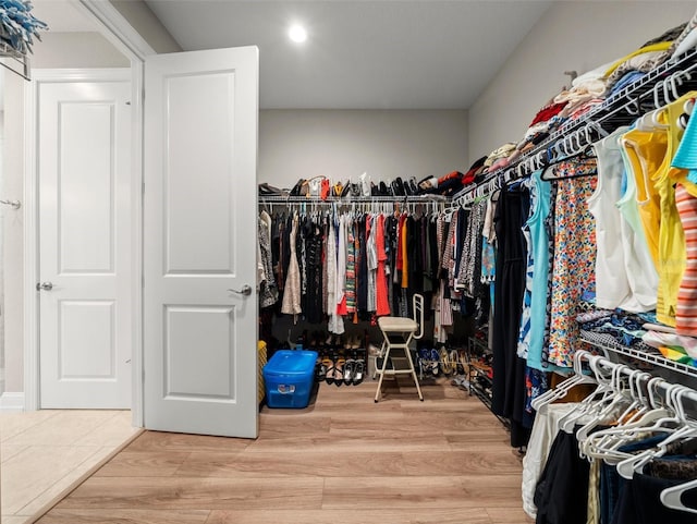 spacious closet featuring light hardwood / wood-style floors